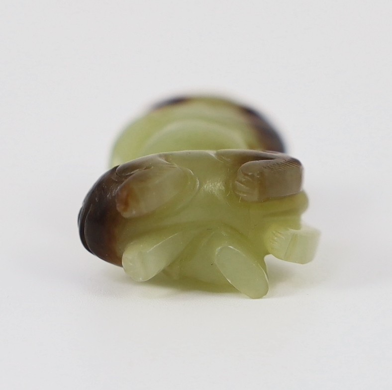 A Chinese yellow and brown jade figure of a man seated on a creature, 19th century, 4.3cm high